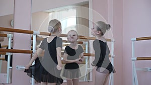 Children's ballet school. Little girls training at the ballet barre.