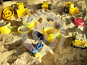 Children's beach toys on sand on a sunny day