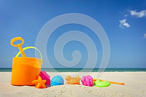 Children`s beach toys on sand on a sunny day