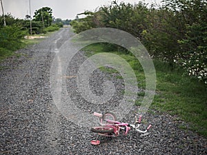 Children`s bikecycle and shoe on stone road. missing children co