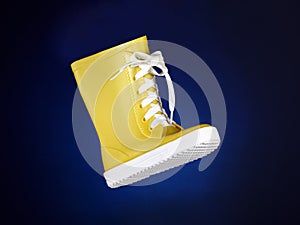 Children`s boot on blue background