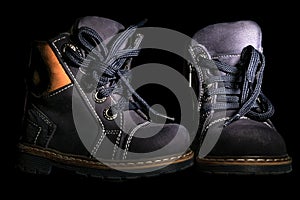 Children's boots on a black background