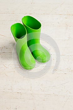Children`s boots.Pair of children green rubber boots, gumboots for rainy days.Fall, Autumn or spring concept - kids