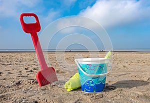 Children`s bucket and spade on a beach