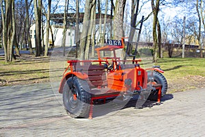 Children's car with wooden seats and ladder. Used as a photo zone. A stationary giant toy.