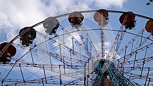 Children's carousel in an amusement park on a background of blue sky