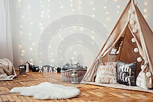 Children`s Christmas Location. Beige Wigwam Decorated. Photo Zone for children in Rustic Style