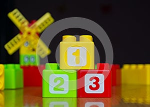 Children`s colored cubes with numbers 1-2-3 on wooden table