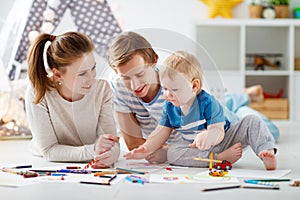 Children`s creativity. happy family mother father and son draw