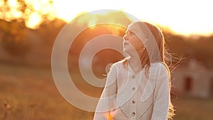 Children's day. Cheerful little child caucasian girl 5-6 years enjoys autumn holiday on sunset lights at nature