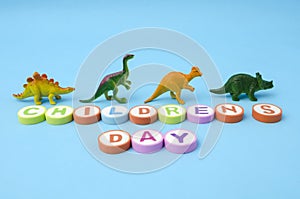 Children`s Day made from colorful letters and plastic dinosaur toys