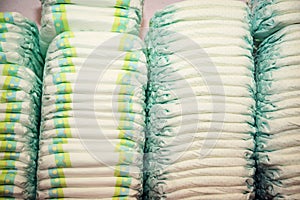 Children's diapers stacked in a many piles
