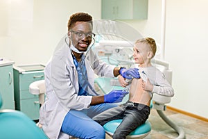 Children`s doctor examining little boy in hospital