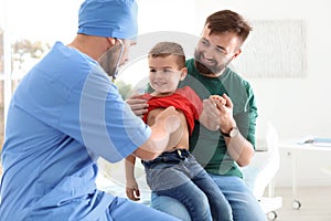 Children`s doctor examining little boy with stethoscope