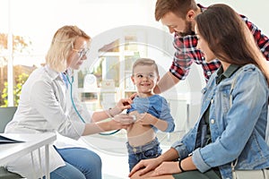 Children`s doctor examining little boy with stethoscope