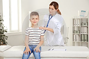 Children`s doctor examining patient with stethoscope