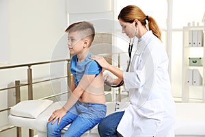 Children`s doctor examining patient with stethoscope