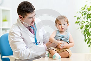 Children's doctor exams infant child with