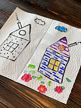 Children`s drawing on a napkin, colored house, drawn with markers