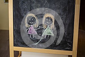Children`s drawing of two girls.