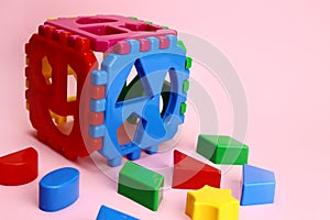 Children's educational game cube sorter on a pink background