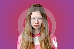 children& x27;s emotions portrait of a sad offended blonde girl in a pink shirt