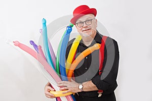 A children`s entertainer holding colorful balloons