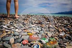 Children`s entertainment on a pebble beach-paint stones.