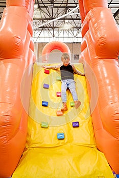 Children`s fair with inflatable castles for jumping and bouncing, children having a good time