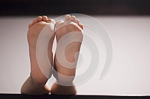 Children`s feet. Bare feet. Foot of the child. photo