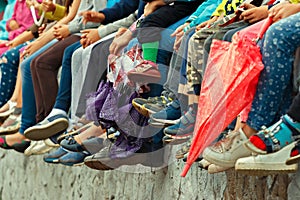 Children`s feet. Bottom view. Spectators of a theatrical performance in the open air