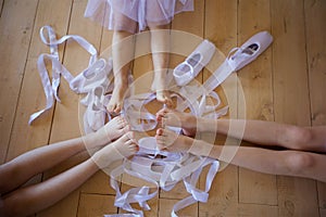 Children`s feet girls engaged in ballet