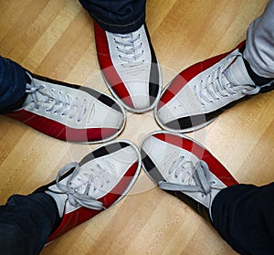 Children`s feet in shoes and a bowling ball