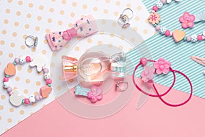 Children`s flat lay. Perfume in the form of candy, children`s jewelry and hair accessories. Accessories for little girls