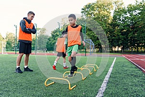 Children`s football players during team training before an important match. Exercises for the youth football team.