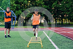 Children`s football players during team training before an important match. Exercises for the youth football team.