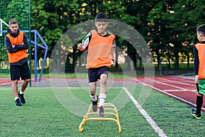Children`s football players during team training before an important match. Exercises for the youth football team.
