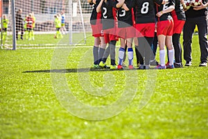 Children`s Football Team on the Pitch. Girls in Black and Red Soccer Uniforms