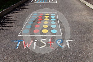 Children`s game twister on the asphalt