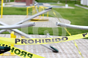 Children`s games cordoned off with yellow tape `Forbidden` due to covid-19 health contingency, new normal