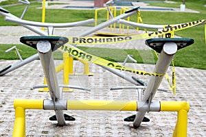 Children`s games cordoned off with yellow tape `Forbidden` due to covid-19 health contingency, new normal