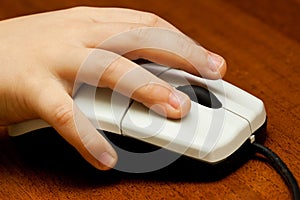 Children's hand on computer mouse