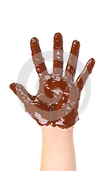 Children's hand stained with chocolate frosting.