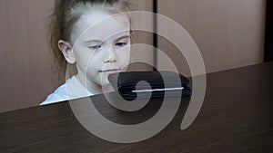 Children's hand stealing wallet. Purse on the table