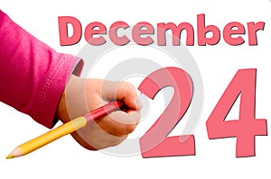 Children`s hand writes December 24 in red pencil.