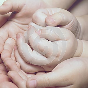 Children`s hands close up. New family, Maternal love and baby protection concept