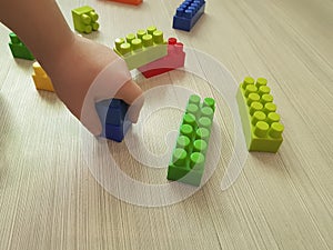 Children`s hands with colorful creative bricks kindergarten