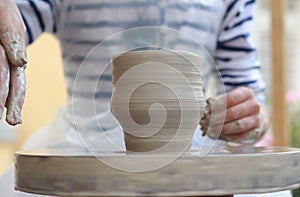 Children's hands creating new vase