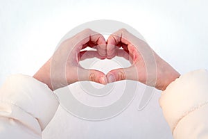 Children`s hands depict the heart.
