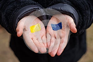 Children`s hands with the flag of ukraine. Antiwar support concept. Stop war